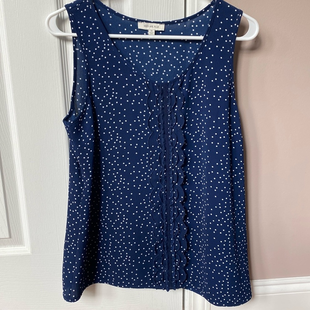 Navy blue polka dot skies are blue top